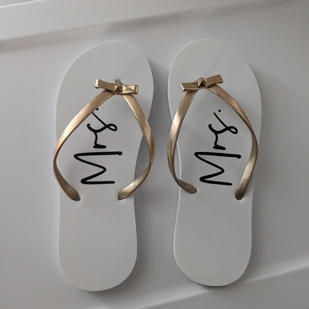 Elegant White Flip Flops with Gold Bow